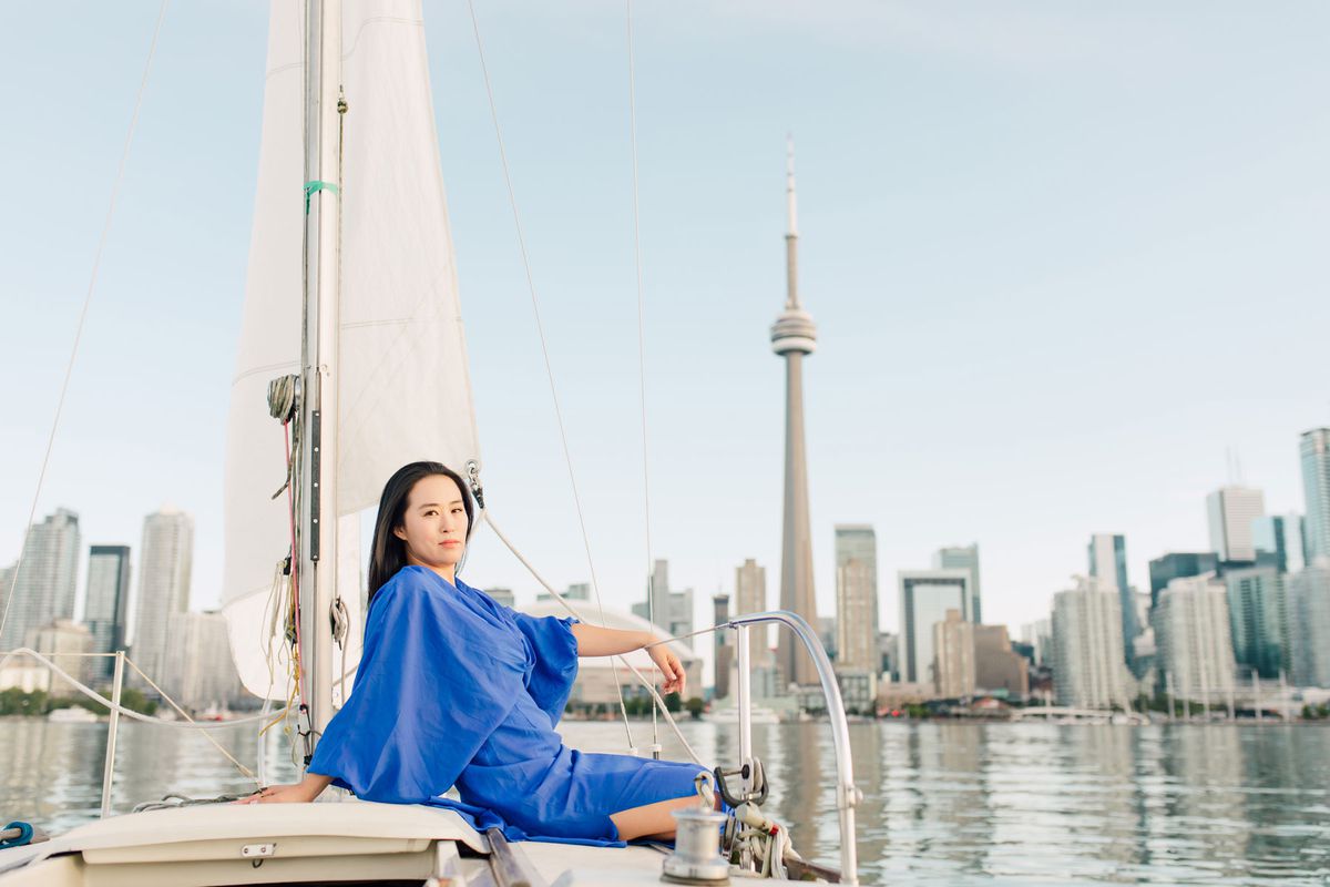 Anna Kim on boat in front of Toronto Skyline