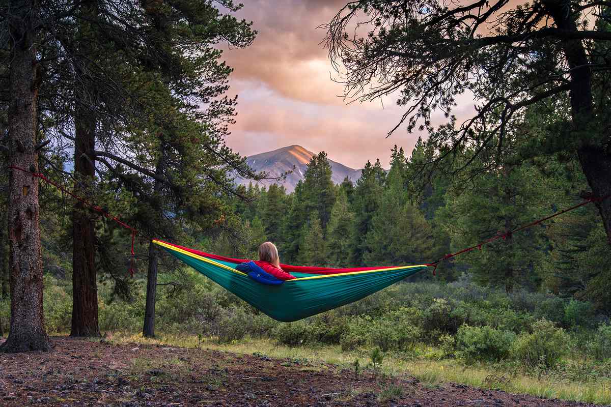 Woman resting in hammock at forest in Leadville, Colorado,