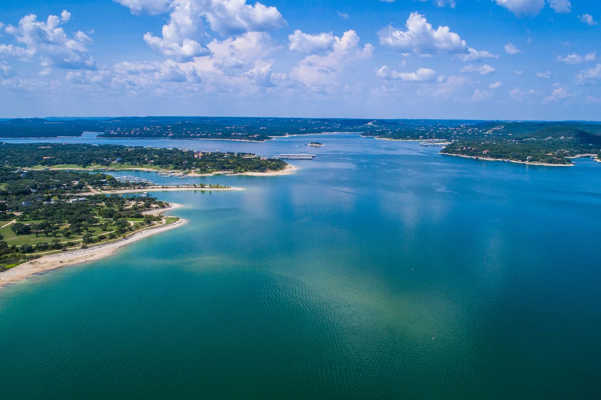 Aerial view above Lake Travis and Lakeway Homes along Water's Edge