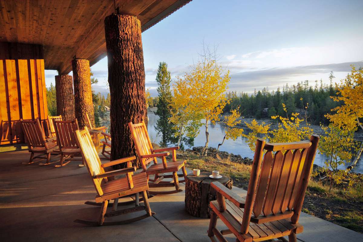 Outdoor rocking chairs and view of the water at Henry's Fork Lodge in Idaho