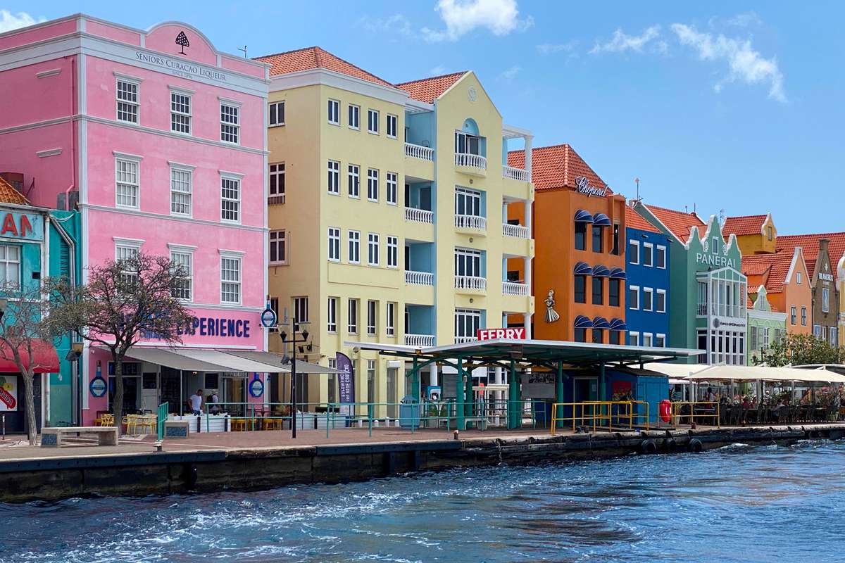 pastel colored colonial buildings on the waterfront of old town Willemstad, Curacao