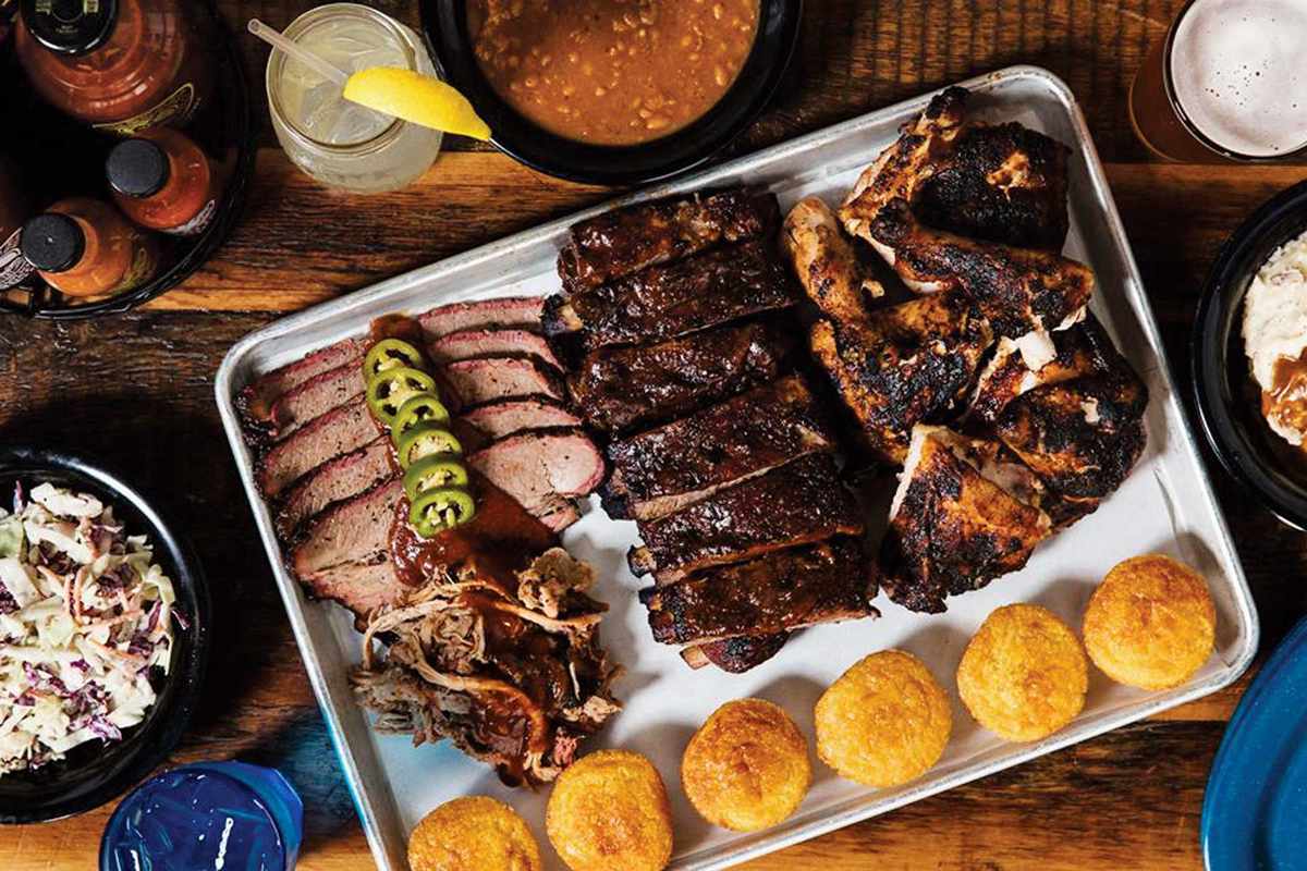 A platter of barbecued meats, and sides, from Dinosaur Bar-B-Que