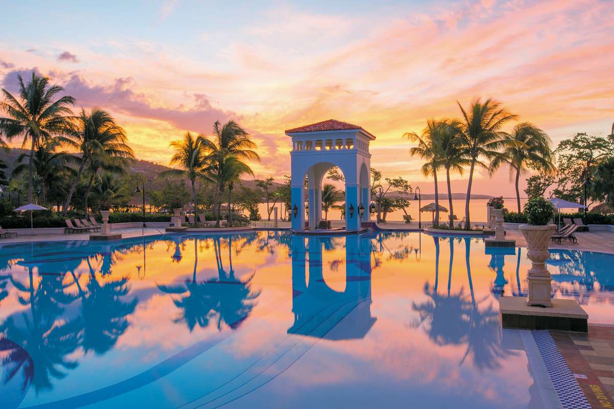 A sunset view at the pool at Sandals South Coast
