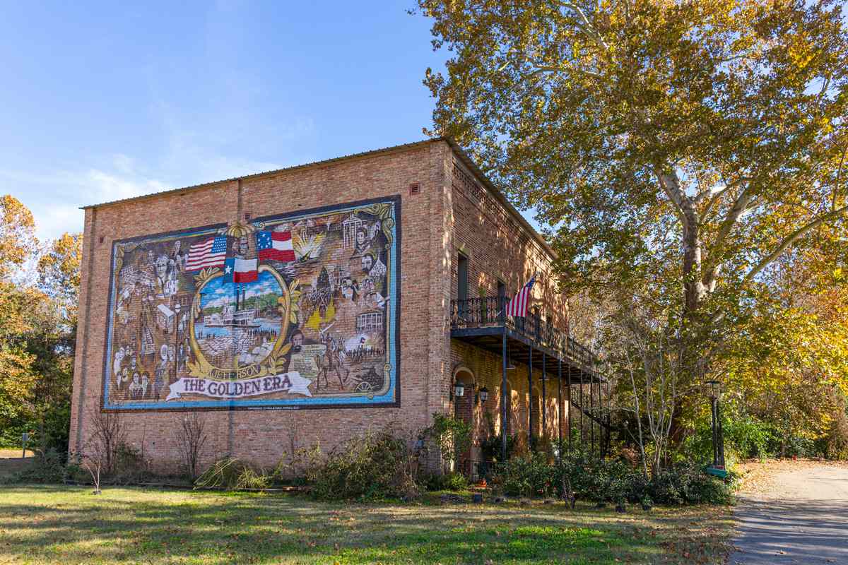 Old historic building with a mural of the Golden Era in the city of Jefferson, Texas