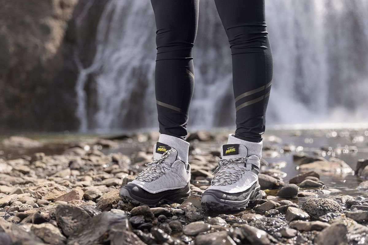 A woman wearing a grey pair of Sweatpant Boots by Inspired by Iceland