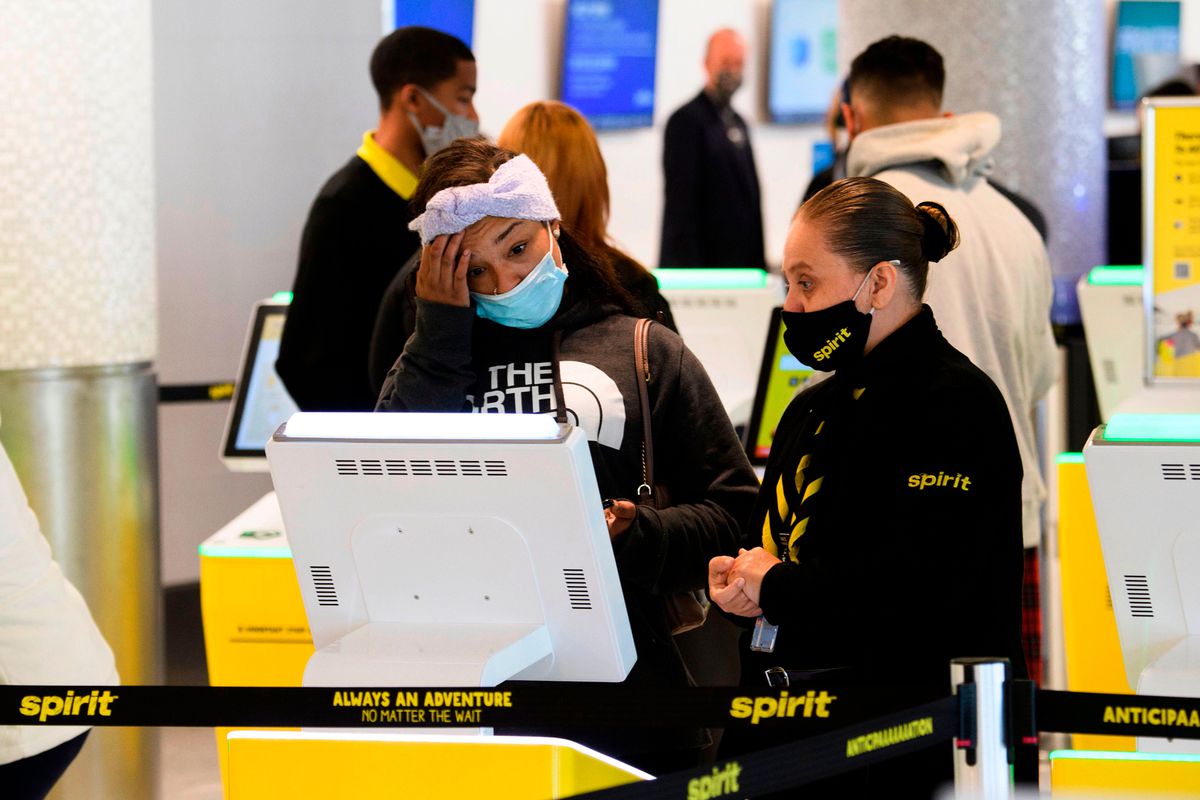 A passenger checks in for a Spirit Airlines flight at Los Angeles International Airport ahead of the Thanksgiving holiday in Los Angeles, California, November 25, 2020