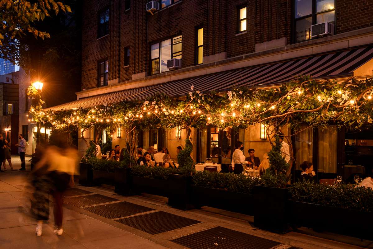 Evening view of whimsical patio lit by fairy lights at Hancock St