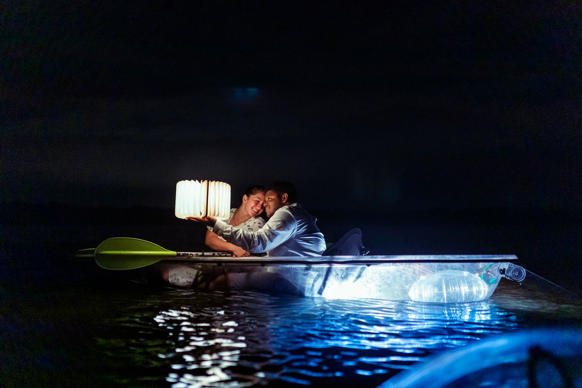 Couple in a clear-bottom kayaks in the bioluminescence water