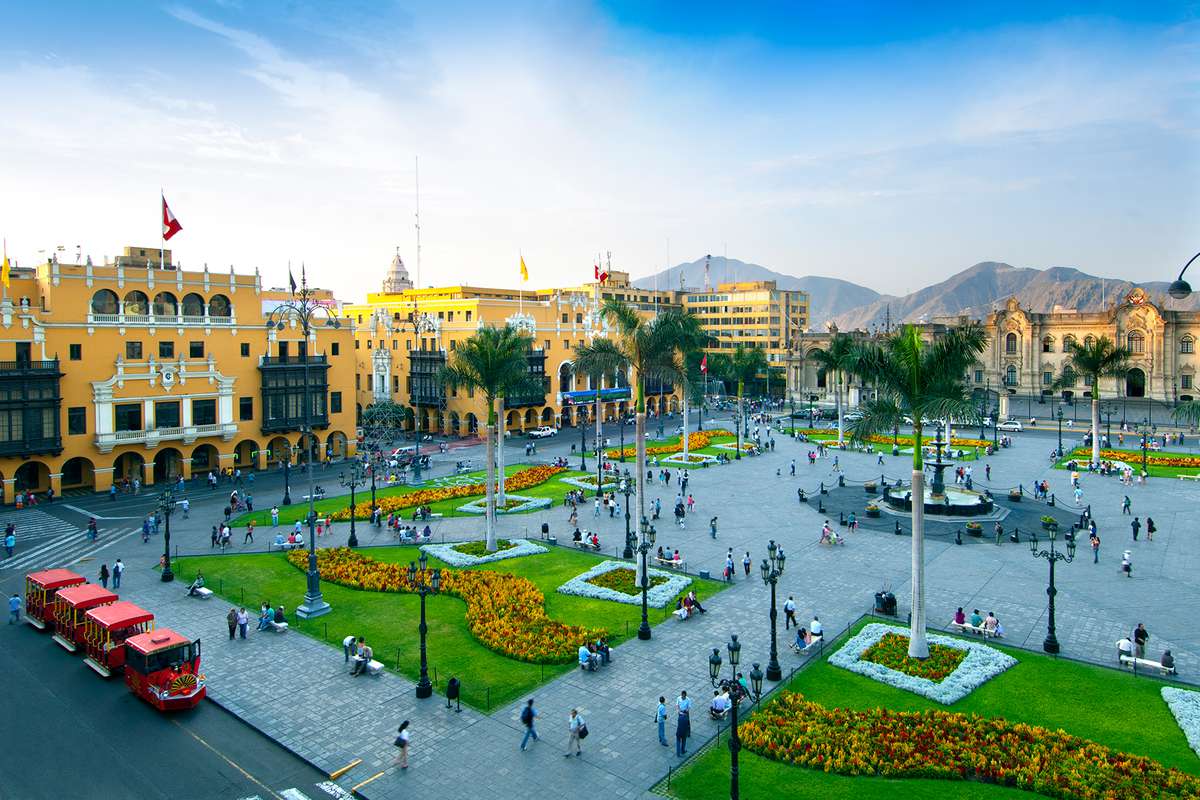 The Plaza Armas (also known as Plaza Mayor) is the main square in downtown Lima, Peru. The Presidential Palace and Spanish colonial style yellow painted buildings surround the well manicured plaza.