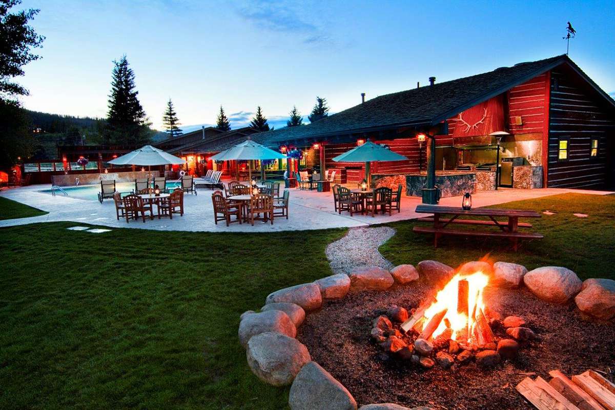 Exterior of C Lazy U Ranch at dusk with the firepit going during summer