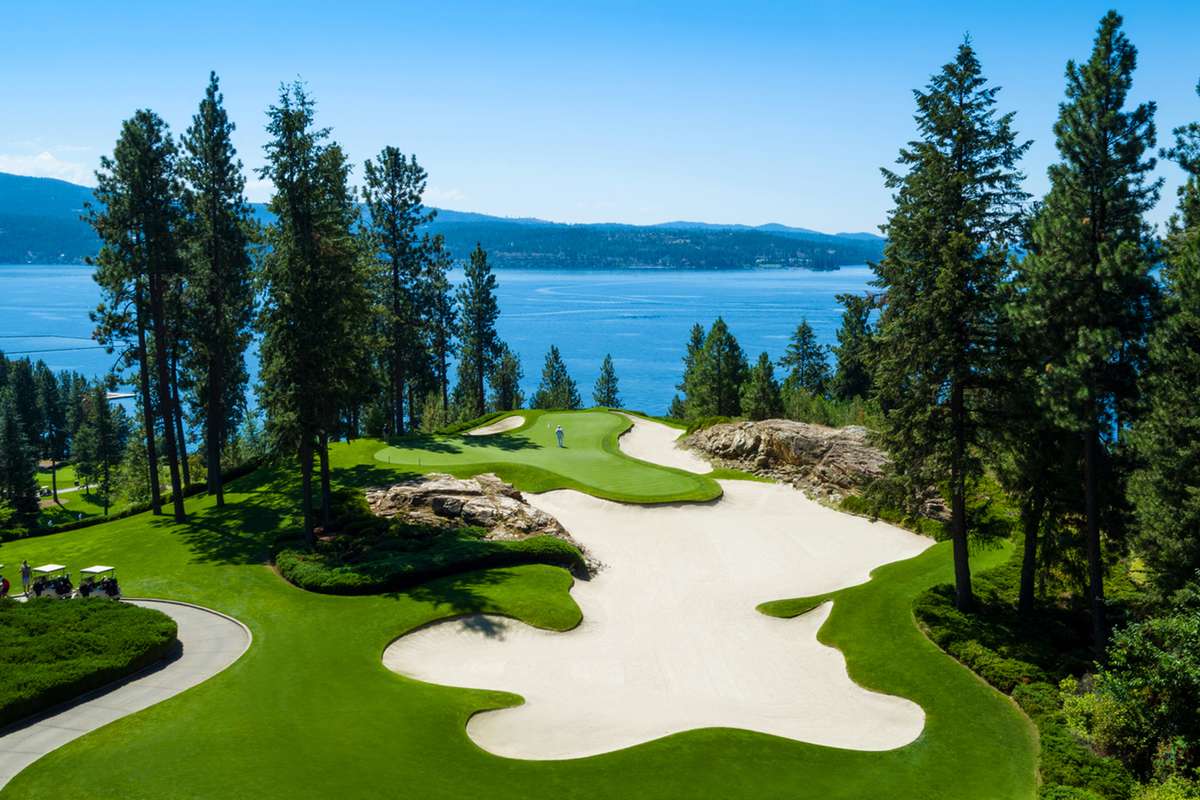 The waterside golf course with tall pines at The Coeur d'Alene Resort, Idaho