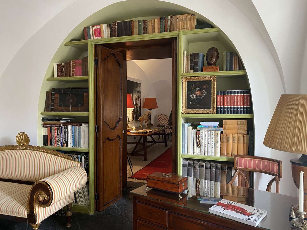 Villa Don Arcangelo all'Olmo study lined with books and mahogany desk