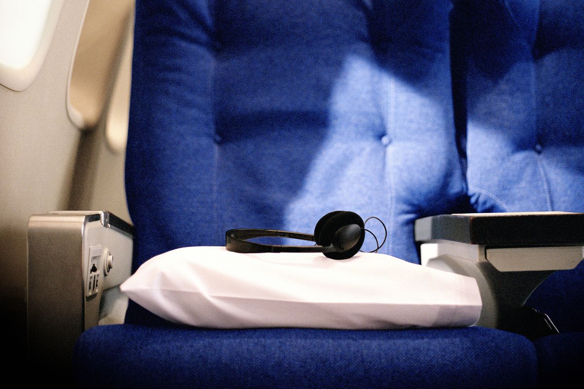 Pillow and headphones on seat in airlines