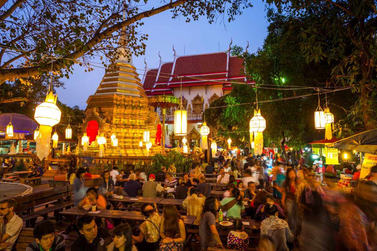 Diners at tables lit by hanging lanterns in Chiang Mai, Thailand, voted one of the best cities in the world