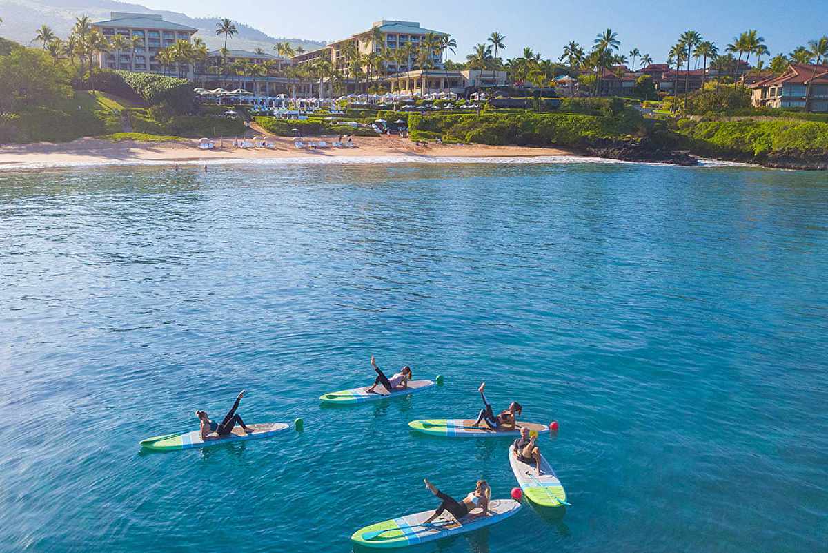A HIIT fitness class on paddle boards at Four Seasons Maui