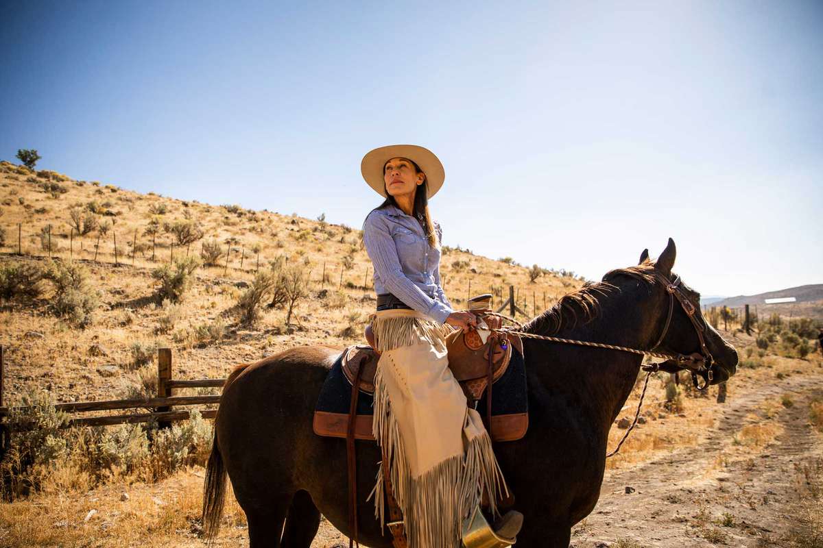 Woman on horseback with western attire at The Lodge at Blue Sky, Auberge Resorts Collection