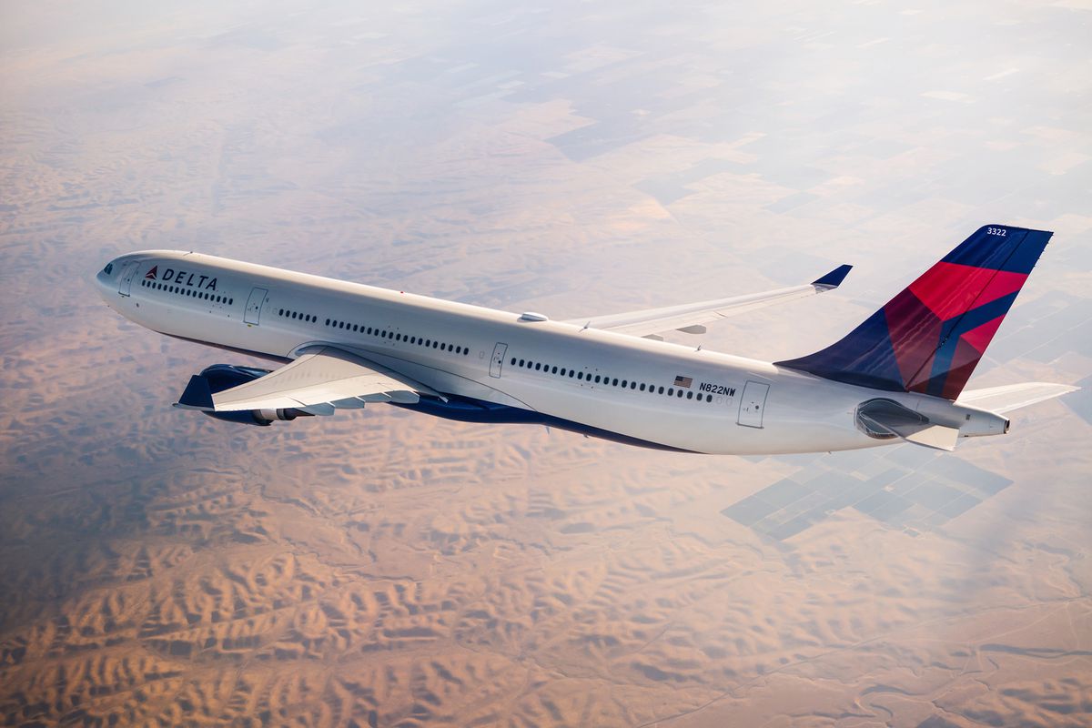 A Delta Airbus 330-300 (333) flying over mountains.