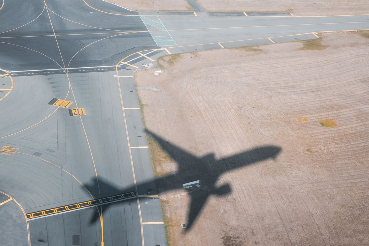 Shadow of airplane taking off from airport