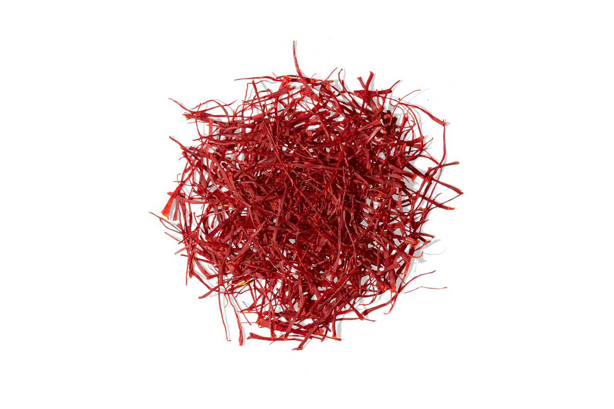 A pile of saffron threads from Moonflowers, photographed on white background
