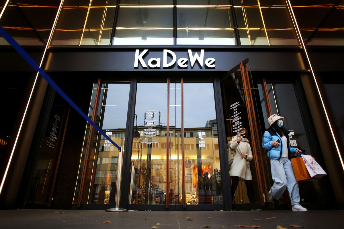 Customers wearing protective face masks as they exit the KaDeWe luxury department store, operated by Signa Prime Selection AG, in Berlin, Germany