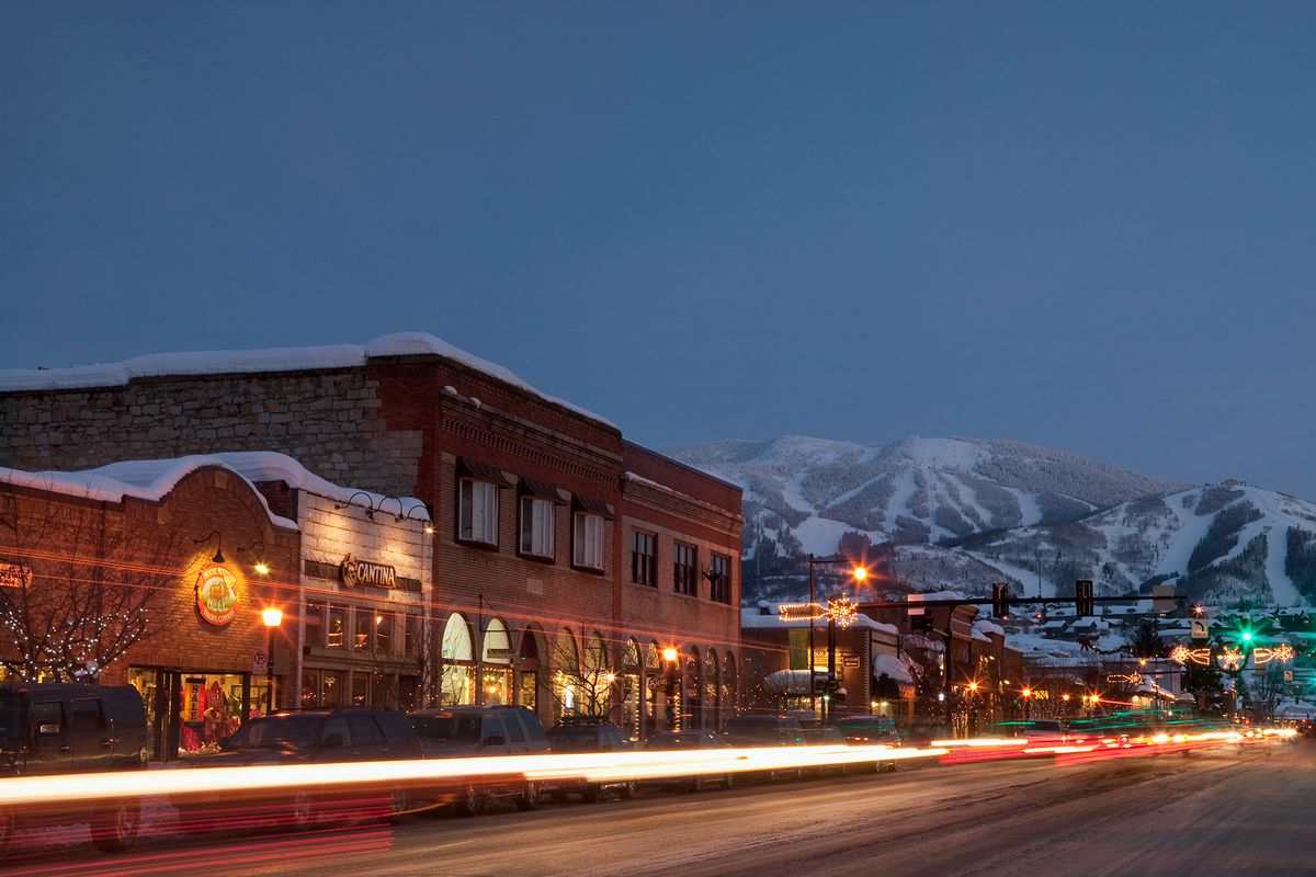USA, Colorado, Steamboat Springs, Town at night with mountains in background