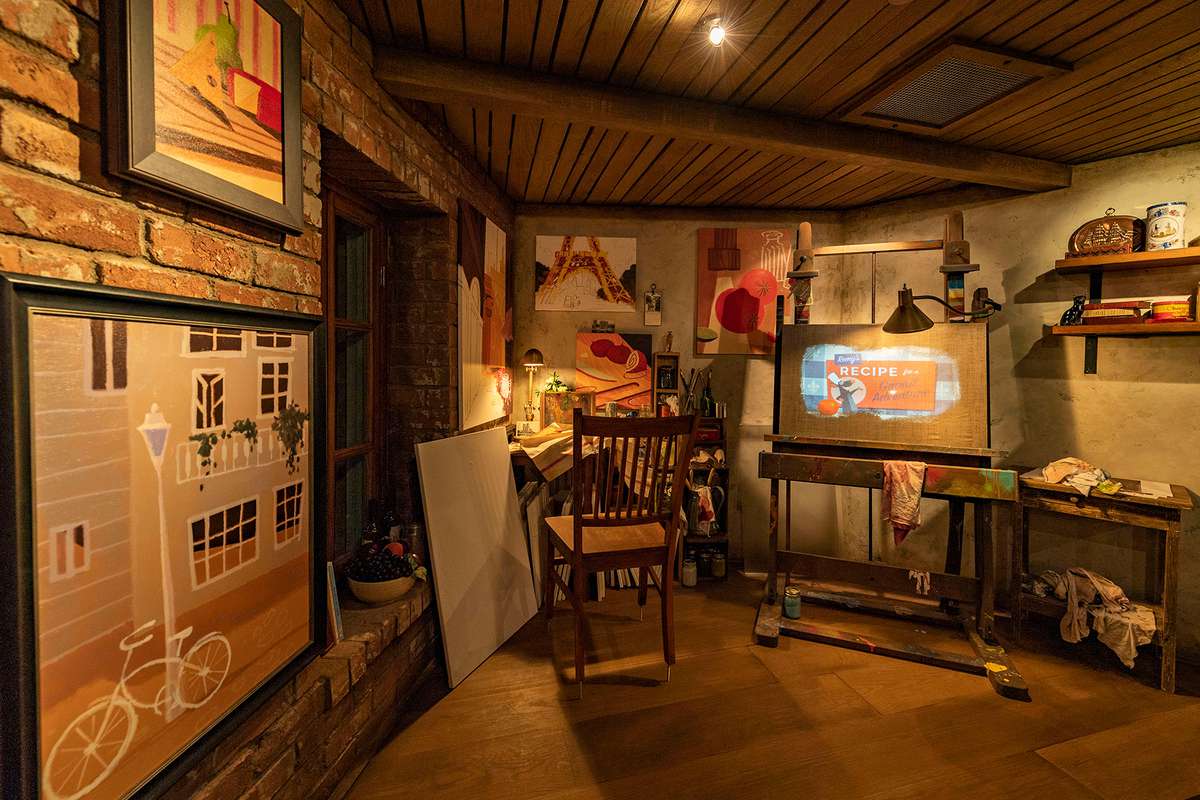 Guests enter a French artist’s loft featuring French-inspired paintings, cupboards filled with art supplies and two magical canvases that come to life in the queue for Remy’s Ratatouille Adventure in EPCOT at Walt Disney World Resort in Lake Buena Vista, Fla.
