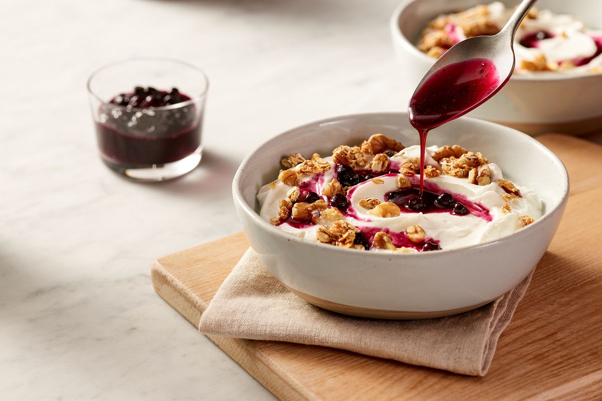 A bowl of Plain Yogurt with Granola, Walnuts and Blueberry Compote from Marriott