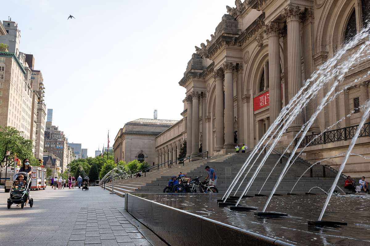 People wearing masks are seen outside The Metropolitan Museum of Art