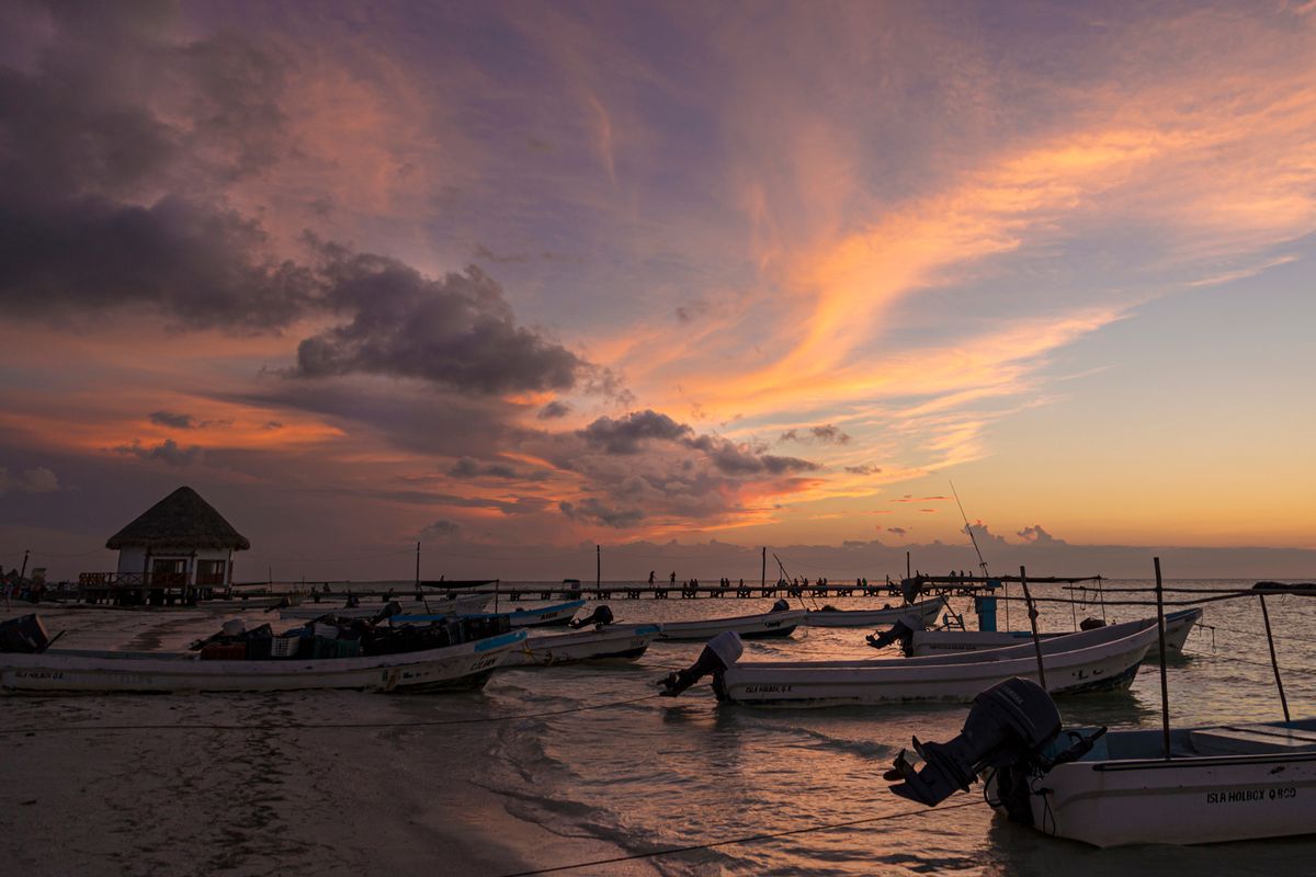 Boats ashore at sunset in Holbox, Mexico