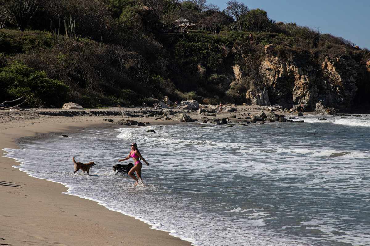Locals and tourists enjoy the beaches and landscapes of Punta Zicatela, Puerto Escondido Oaxaca Mexico.