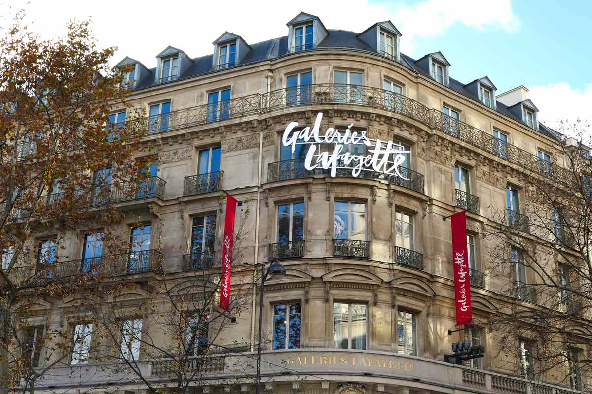 Exterior façade of the famous fashion and luxury store, sign Galeries Lafayette. Located on Haussmann Boulevard.