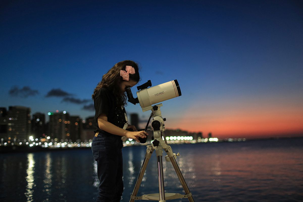 Brazilian 8-year-old astronomer Nicole Oliveira watches the sky with her telescope in Fortaleza, Brazil, on September 21, 2021