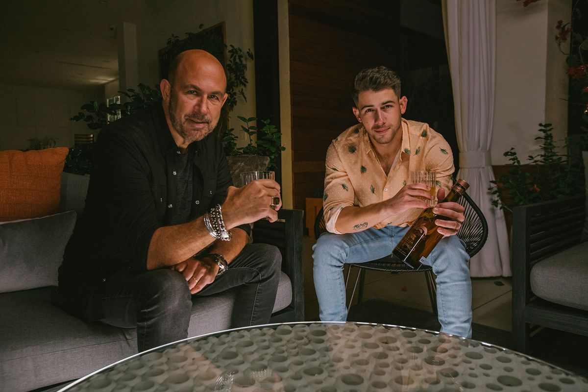 Nick Jonas & John Varvatos with a bottle of Villa One