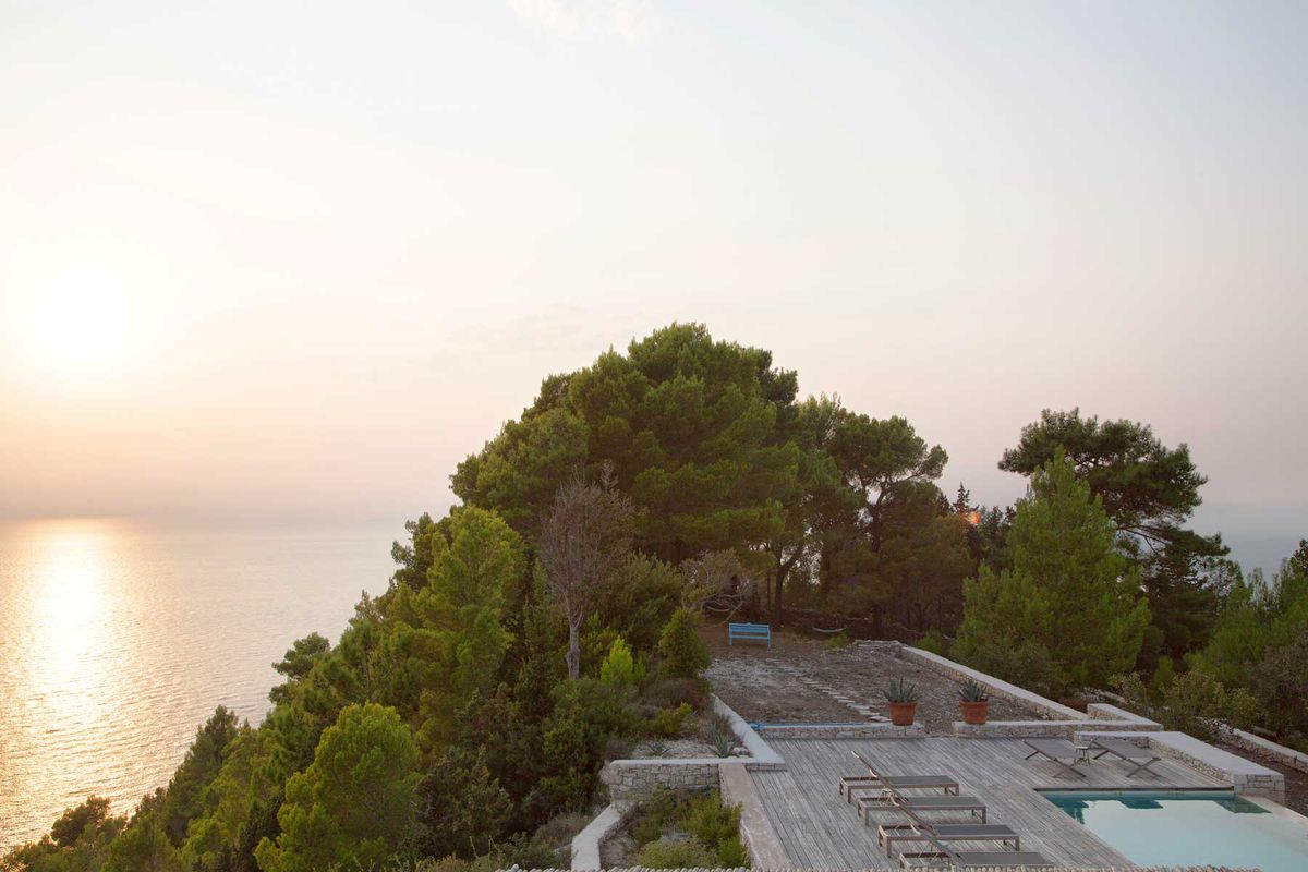 Sunset view from the pool deck of a villa in Greece