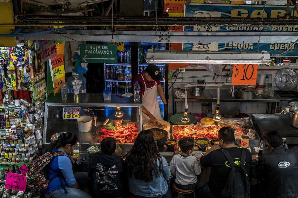 Customers eat at a food stand at the Mercado San Juan de Dios.