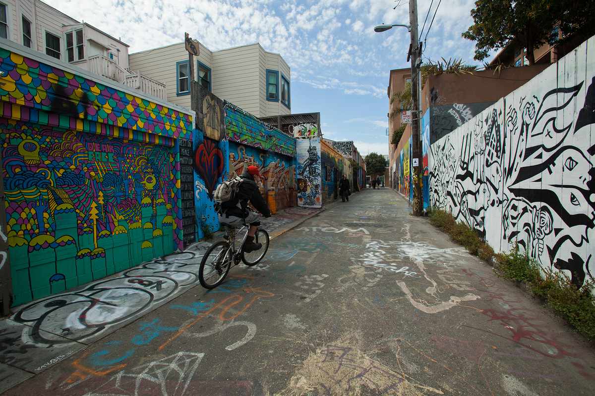 Riding a bike down Clarion Alley past the Mural Project