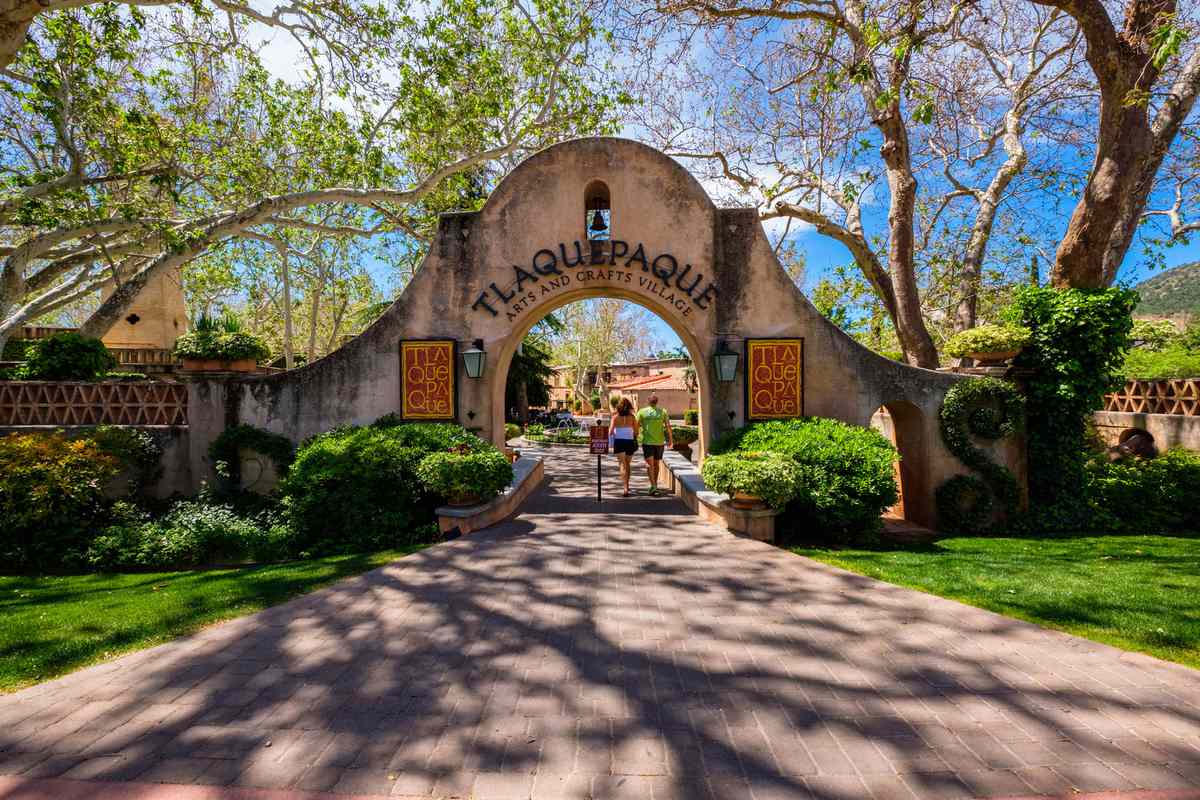 The entrance to the Tlaquepaque Arts and Crafts Village with vintage adobe style architecture and a popular tourist destination filled with retail shops and restaurants.