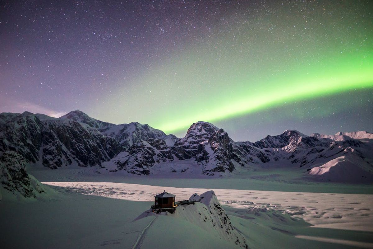 Northern Lights over the Stay One Degree Extraordinary Mountain Chalet in Alaska