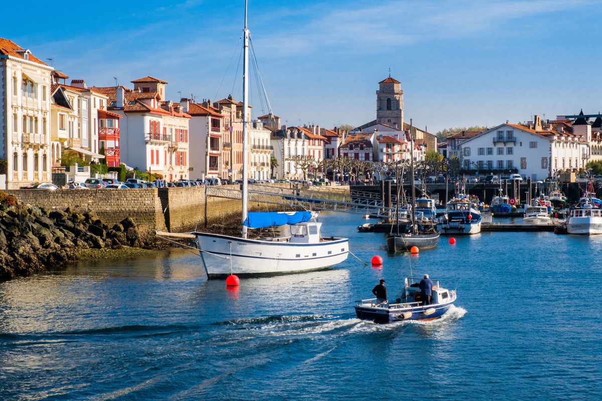 Saint-Jean-de-Luz, The fishing port at the far end of the city.Boats in the port, back from a fishing trip, with the Church of St John the Baptist in the background.
