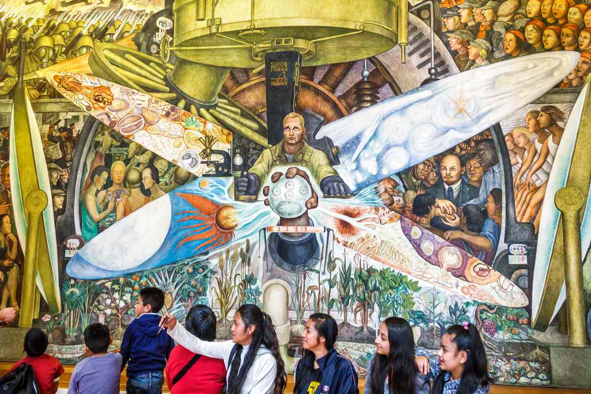Palace of Fine Arts, Art Deco mural by Diego Rivera, Man at the Crossroads, with students taking selfies.