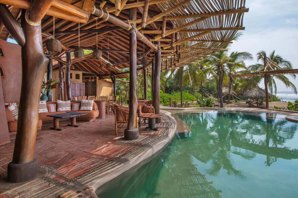 Interior and exterior of Playa Viva's treehouse and pool lounge