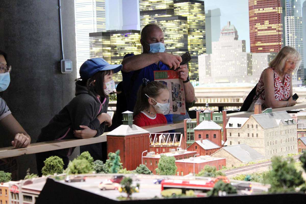 Children and parents look at miniature models of Canada at the Litte Canada miniature museum