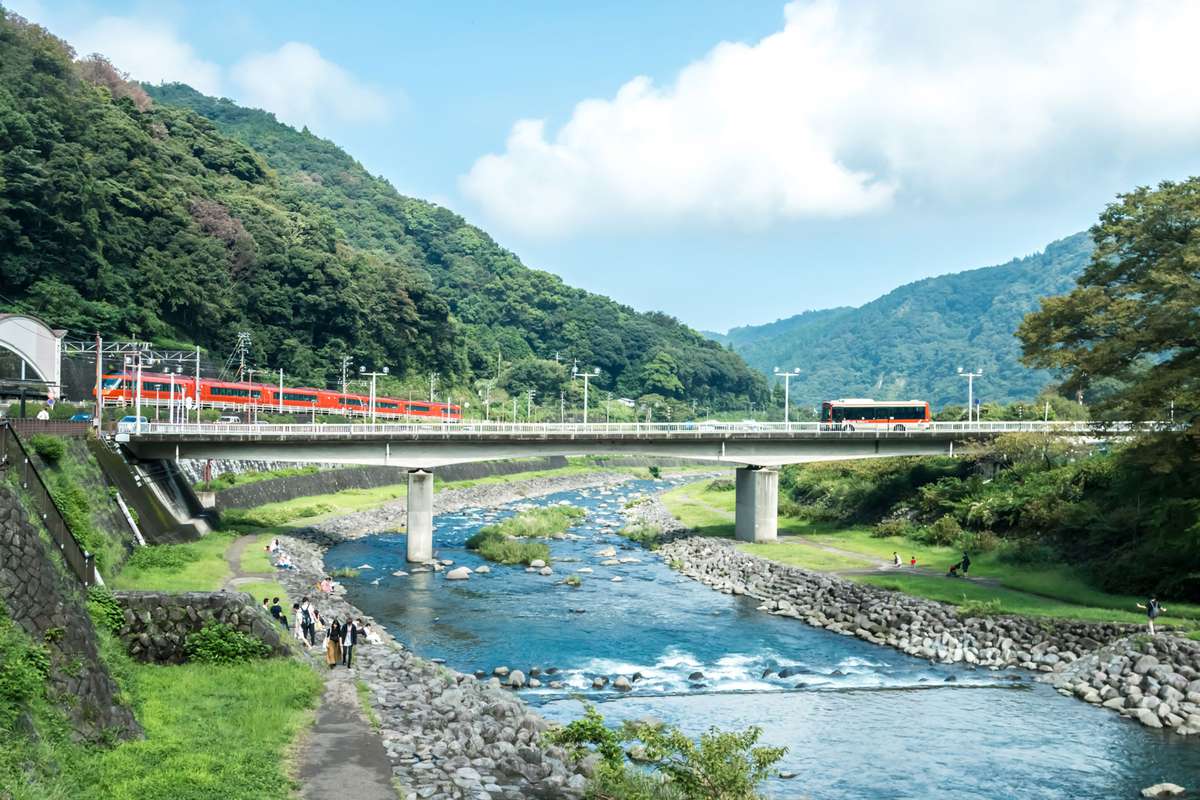 Hakone skyline with mountain, river, clear sky and red train, travel bus in Kanagawa-ken, Japan at day time.