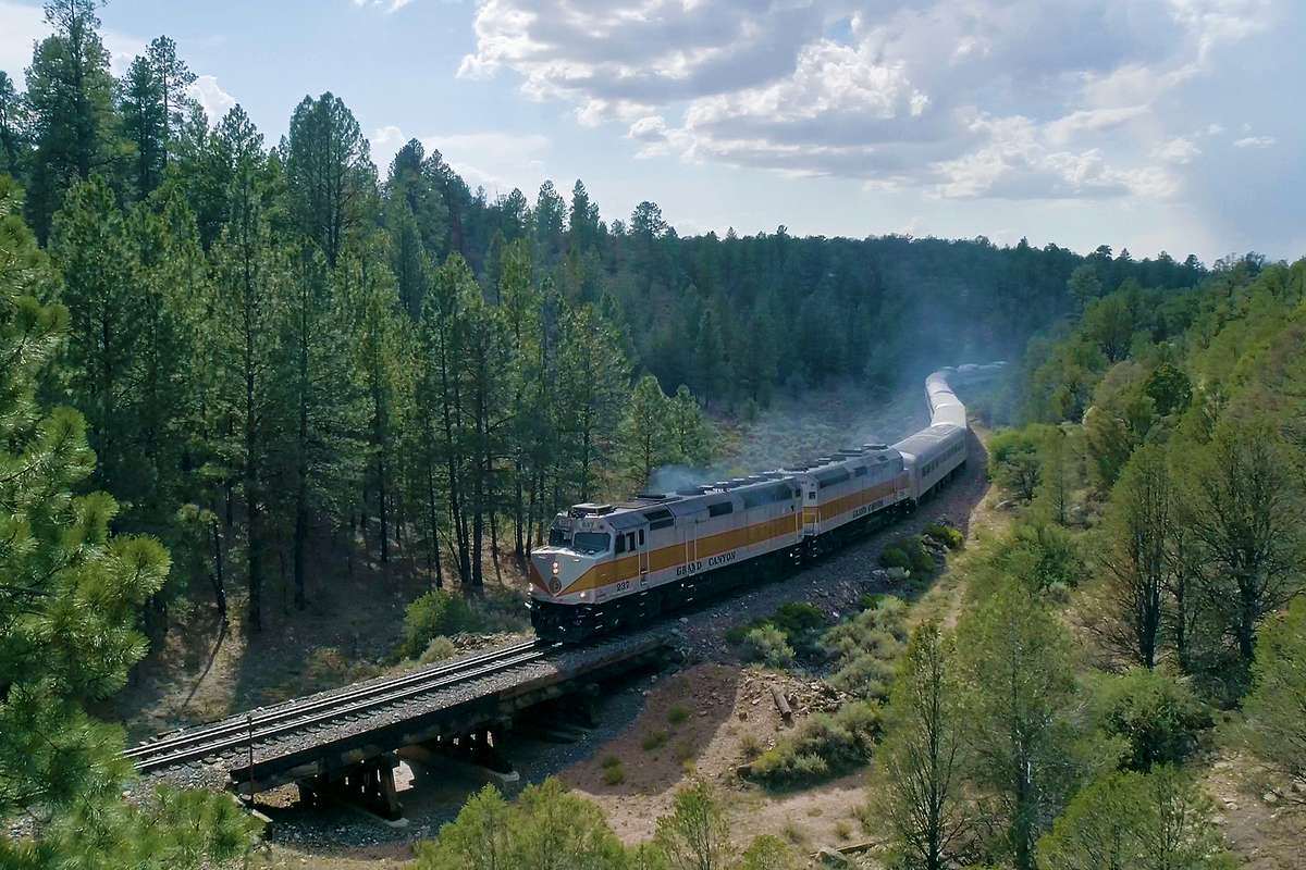 The train going through mountains by The Grand Canyon Railway & Hotel