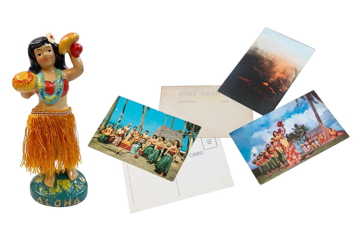 Hula figurine and postcards at the Tin Can Mailman vintage shop in Hawaii
