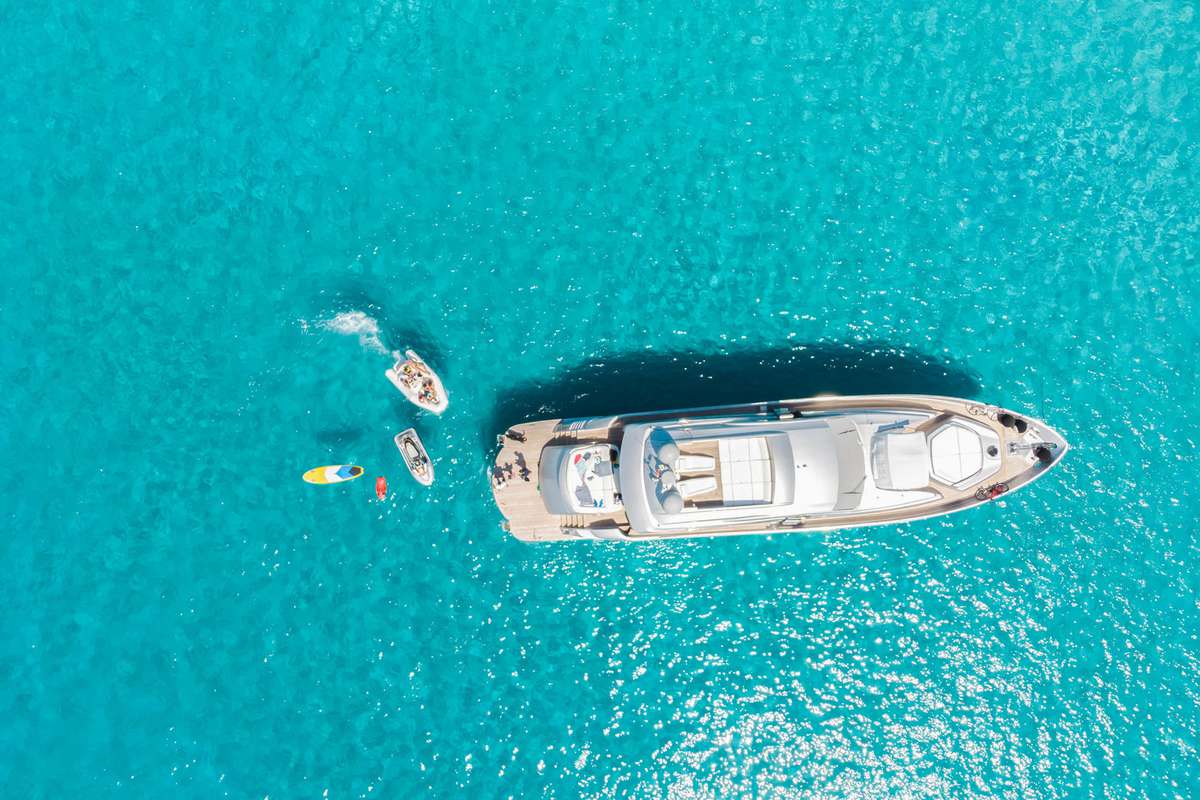 Aerial view of luxury yacht anchored in the transparent sea of the Formentera island in Spain.