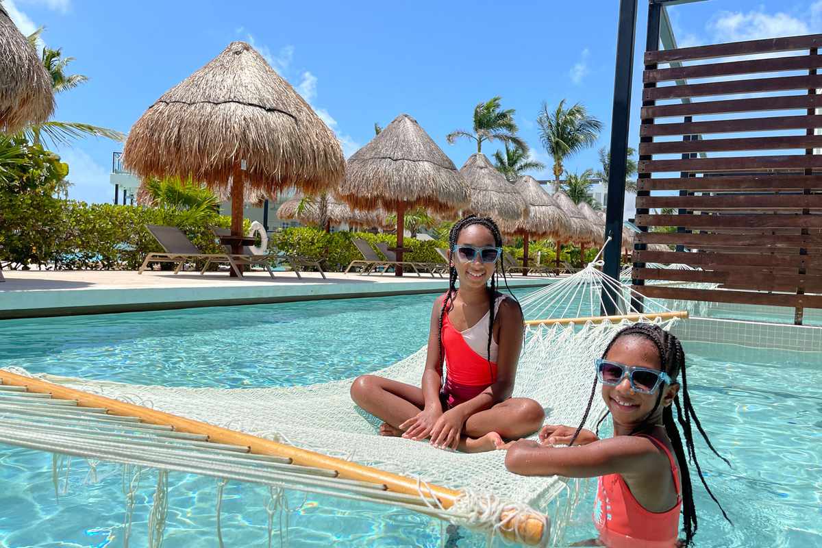 Two young girls enjoying the pool at Playa Mujeres