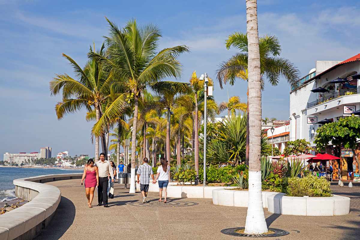 Mexican tourists walking along the Malec—n, esplanade in city Puerto Vallarta