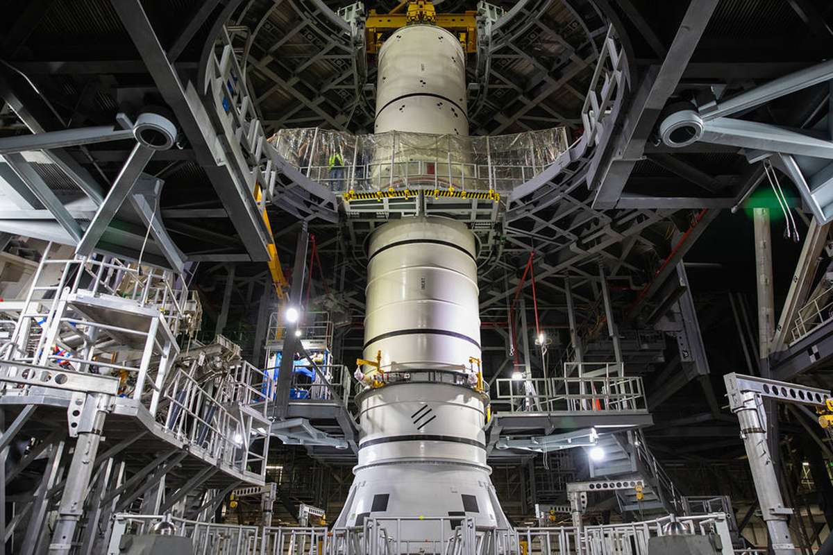 Technicians with NASA’s Exploration Ground Systems lower a mock-up, or pathfinder, of the Space Launch System’s (SLS) center booster segment onto an aft pathfinder segment inside the Vehicle Assembly Building (VAB) at the agency’s Kennedy Space Center in Florida on Sept. 14, 2020. Teams rehearsed stacking both pathfinder segments on top of the mobile launcher in High Bay 3 of the VAB in preparation for the Artemis I launch.