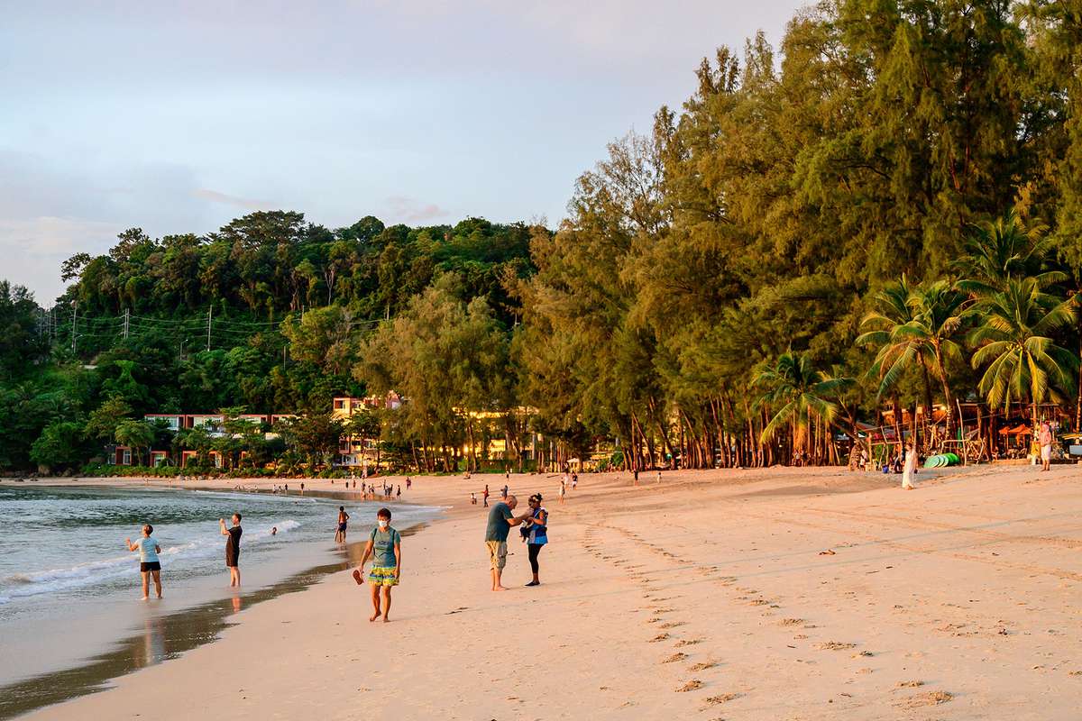 people relaxing on a beach on the Thai island of Phuket, as tourists take advantage of the "Phuket Sandbox" programme for visitors fully vaccinated against the Covid-19 coronavirus.